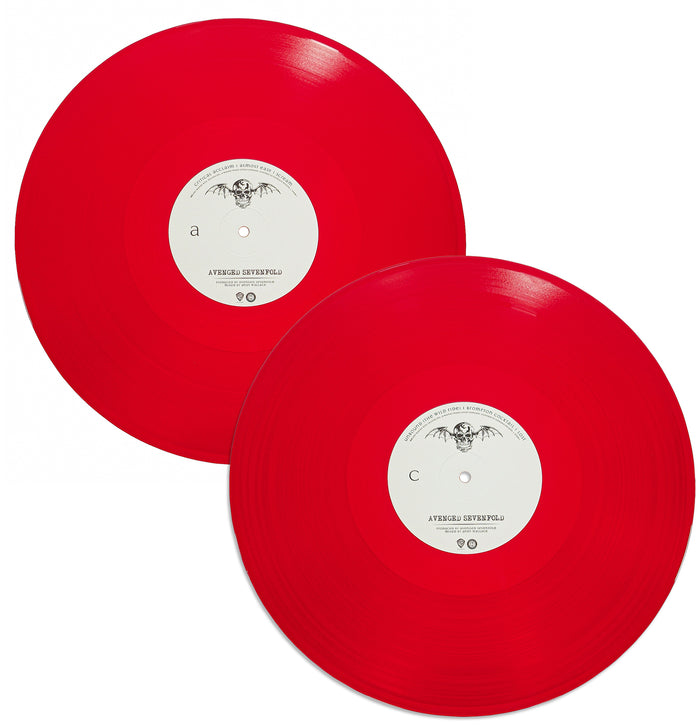 Two bright red vinyl records from an Avenged Sevenfold self-titled 2XLP are displayed side by side, each with a white center label featuring small black text and graphics, including a winged emblem at the top.
