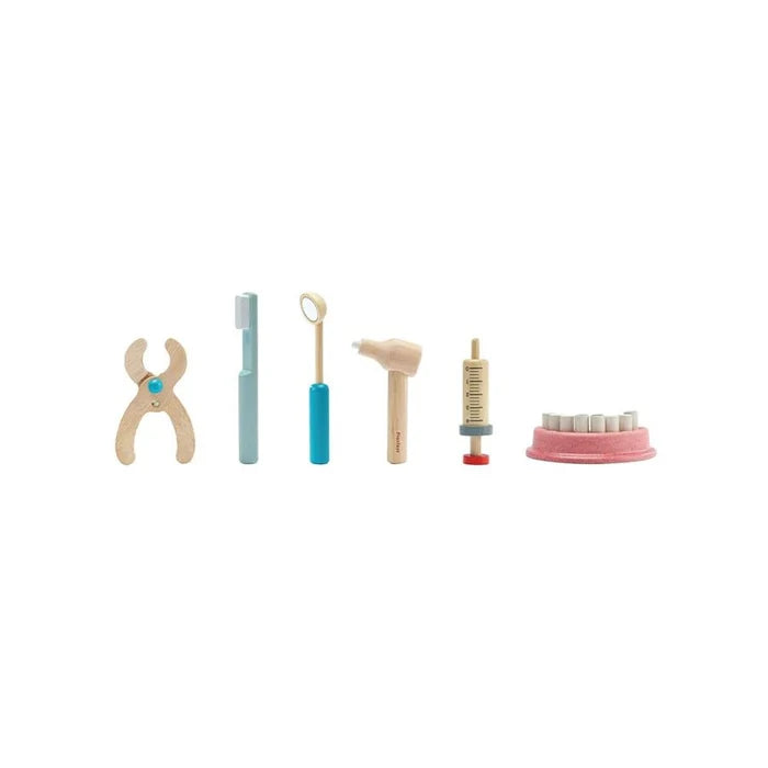 Set of toy dental tools on a white background