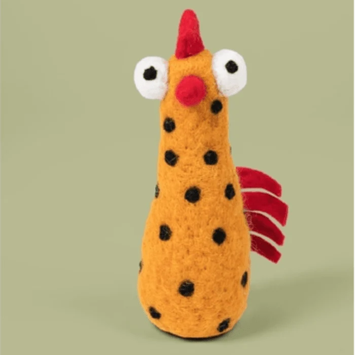 Yellow felted chicken with black dots on a green background