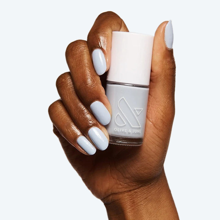 Hand with nails painted in BP, a pastel icy light blue gel polish for a fresh and long-lasting at-home manicure