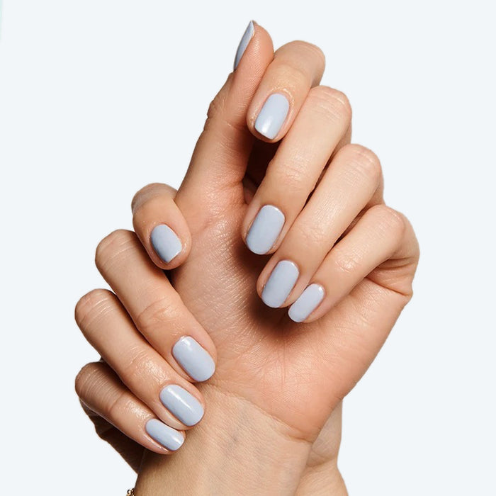 Hands displaying nails painted with BP, a pastel icy light blue gel polish for a fresh at-home manicure
