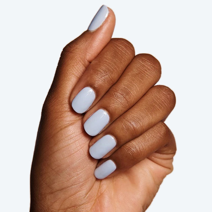 Hand with nails polished in BP, an icy pastel light blue gel polish perfect for a fresh at-home manicure