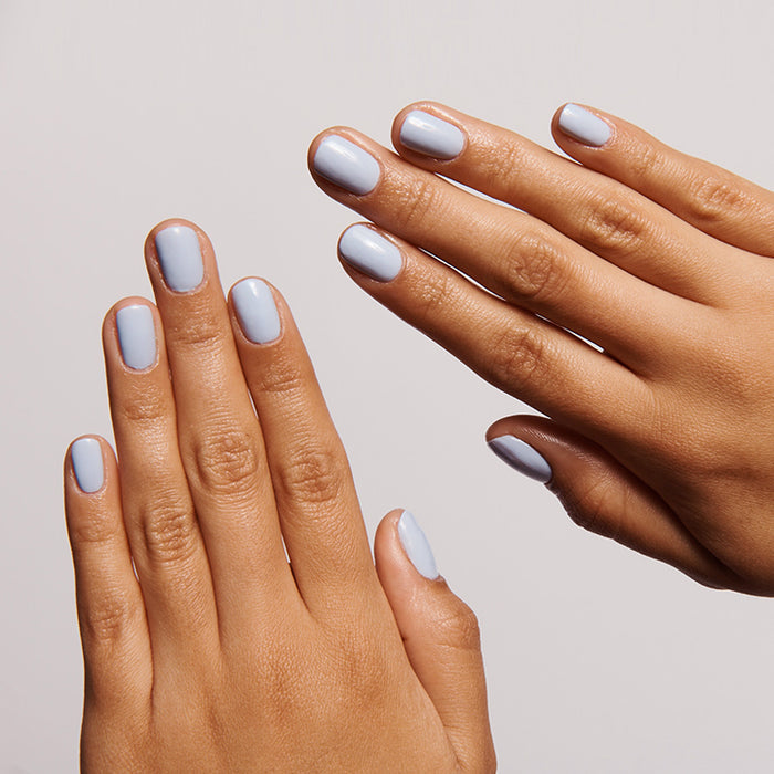 Hands with nails coated in BP, a pastel icy light blue gel polish for a fresh and lasting at-home manicure