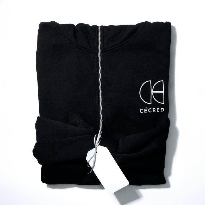 Folded Cécred black zip-up hoodie with logo facing forward, tied with a fabric bow and gift tag against a white background