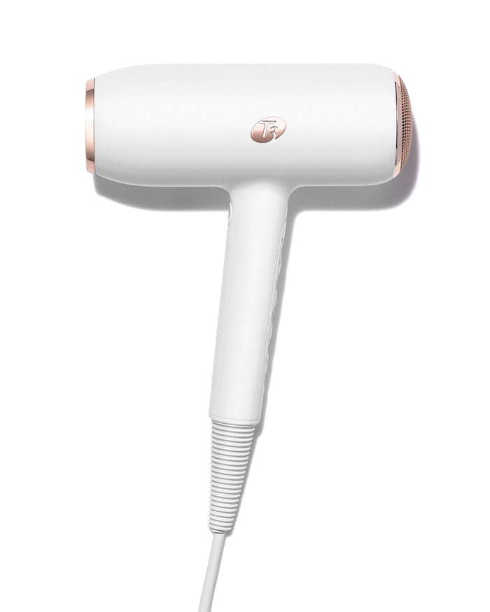 White and rose gold hair dryer on a white background