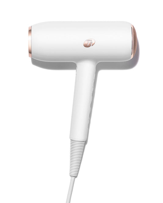 White and rose gold hair dryer on a white background