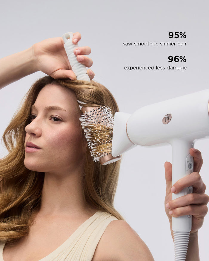Woman using a hair dryer and brush on her hair with text indicating hair quality improvements.
