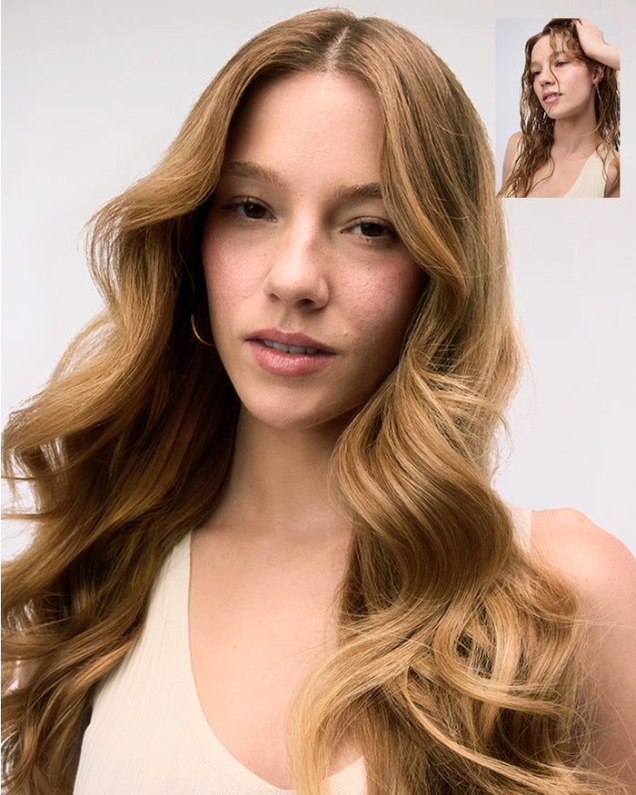 Woman with long, wavy hair against a plain background