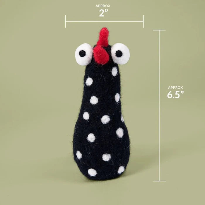 Black polka dot toy with a red beak and white eyes on a green background, showing measurements.