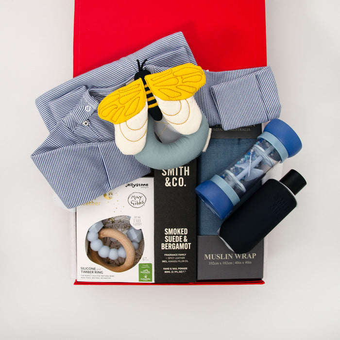 Collection of baby products including a long sleeve romper, bee rattle, teether, muslin wrap hand cream and room spray. $195.00