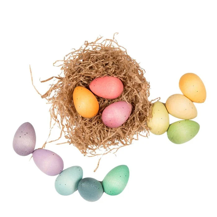 Pastel colored Easter eggs in a nest on a white background