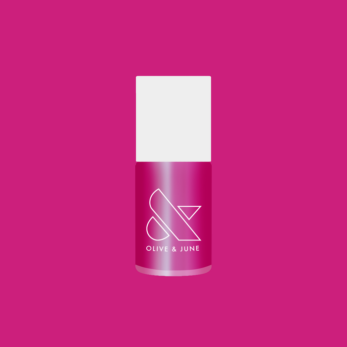 Bottle of HARD LAUNCH quick dry polish in pinky-purple iridescent duochrome shade on a solid pink background