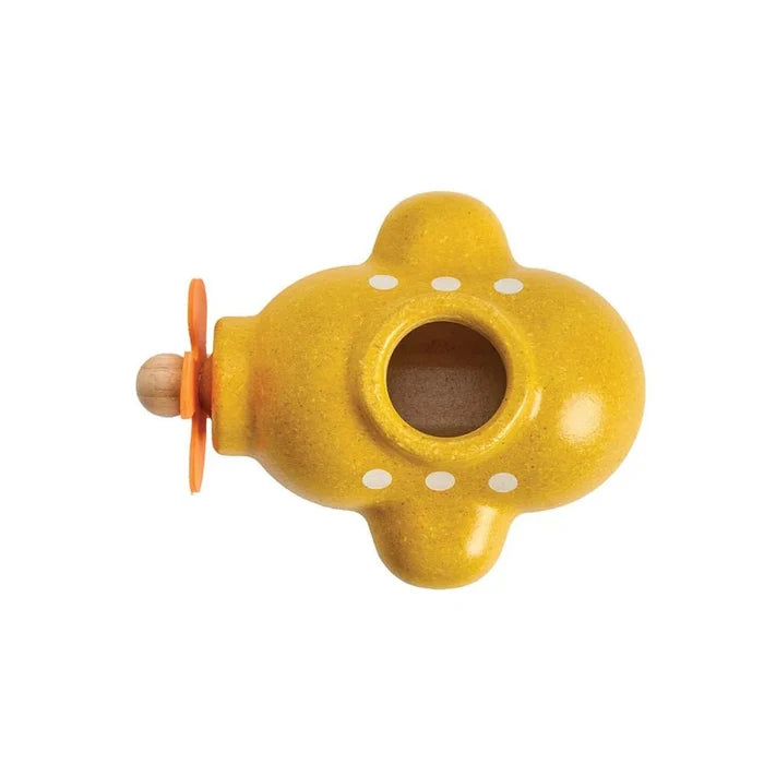 top down view of yellow wooden submarine toy on a white background