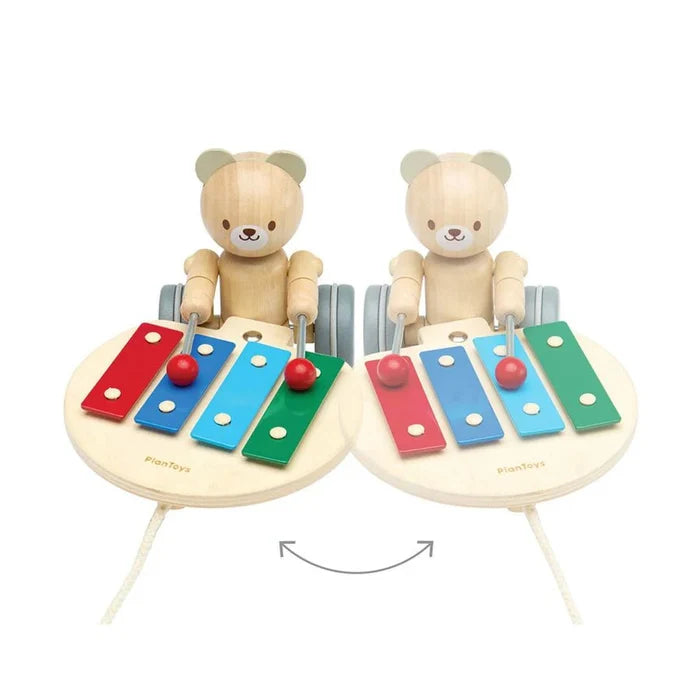 Wooden toy xylophones with teddy bear figures on a white background