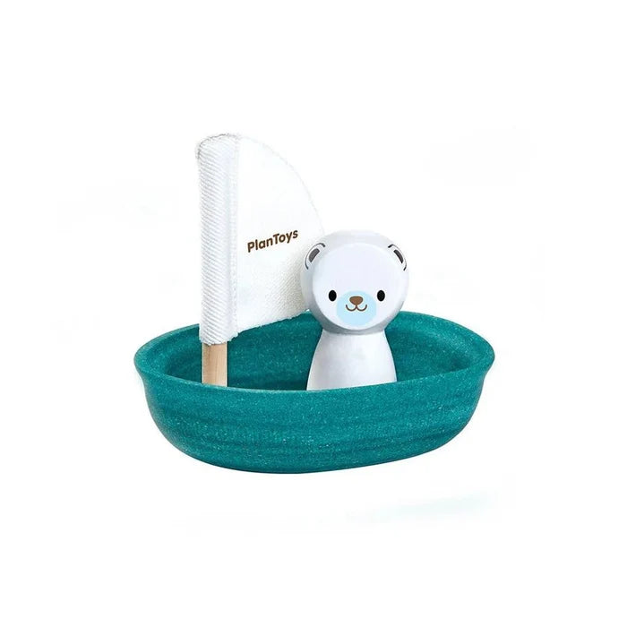 Toy boat with a polar bear and a white flag on a white background