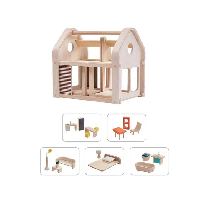 Wooden dollhouse with miniature furniture on a white background