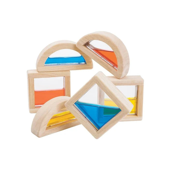 Wooden geometric shapes with colorful water inside on a white background