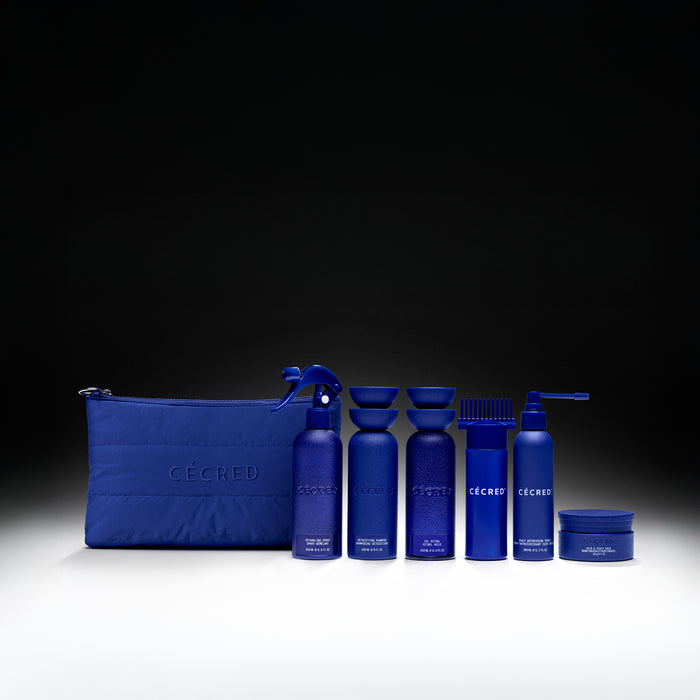 Blue CECRED skincare bundle with pouches, bottles, and jars containing protective products arranged against black background.