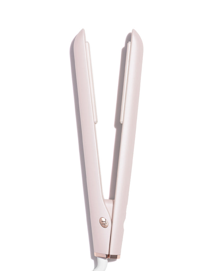Rose gold hair straightener on a white background