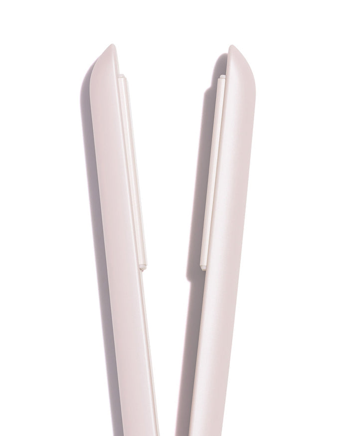 Pink hair straightener on a white background
