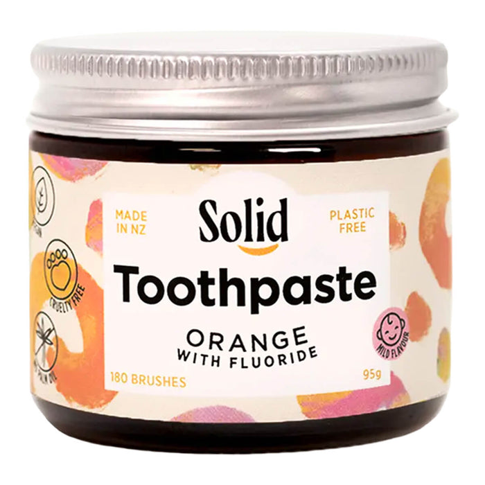 Jar of Solid Toothpaste Orange with Fluoride on a white background