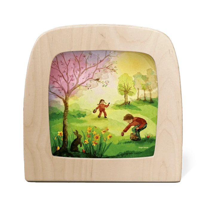 Two children having an Easter egg hunt in a colorful field