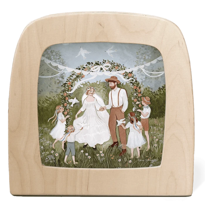 Silhouette of married couple and children under a floral arch