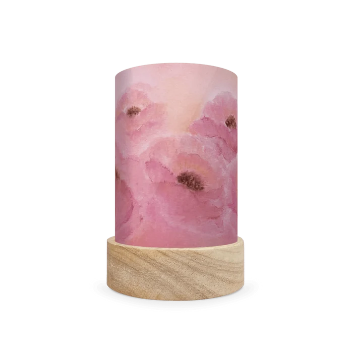 Decorative cylindrical lamp featuring a scene of pink poppies on a white background