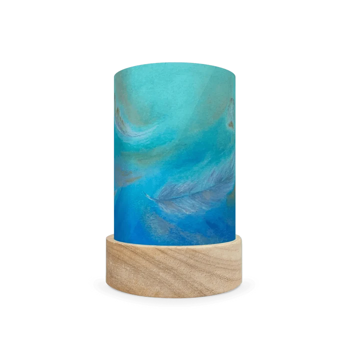 Decorative cylindrical lamp featuring a scene of feathers on a white background