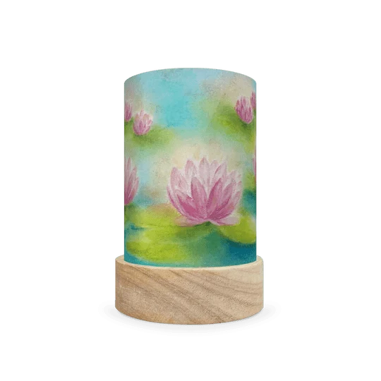 Decorative cylindrical lamp featuring a scene of water lilies in a pond on a white background