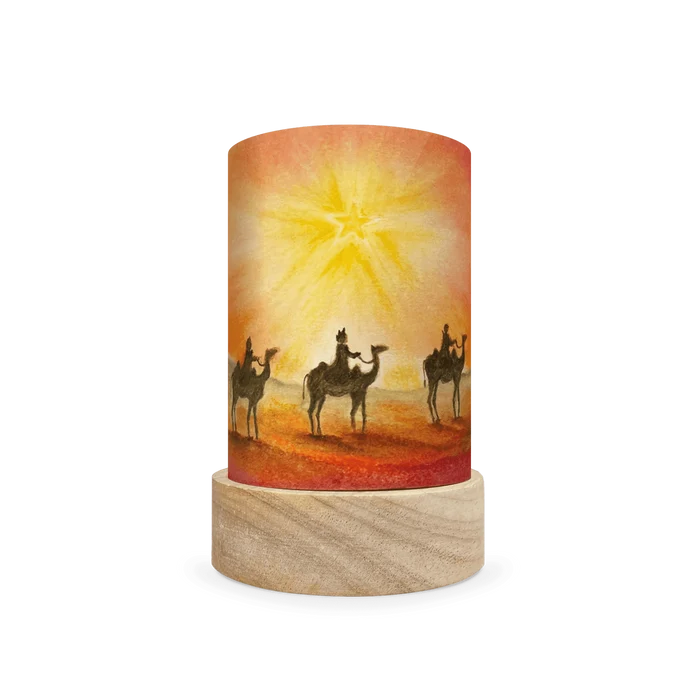 Decorative lamp with a scene of the three wise men traveling on camels in the desert on a white background