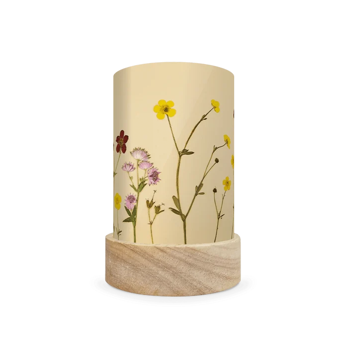 Mini lantern silhouette of pressed yellow, pink, and red flowers on a light background