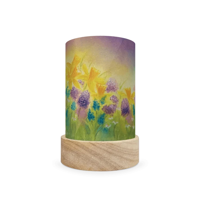 Decorative cylindrical lamp featuring blue and purple spring floral design on a white background