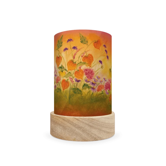 Decorative cylindrical lamp with autumnal orange and pink floral design on a white background